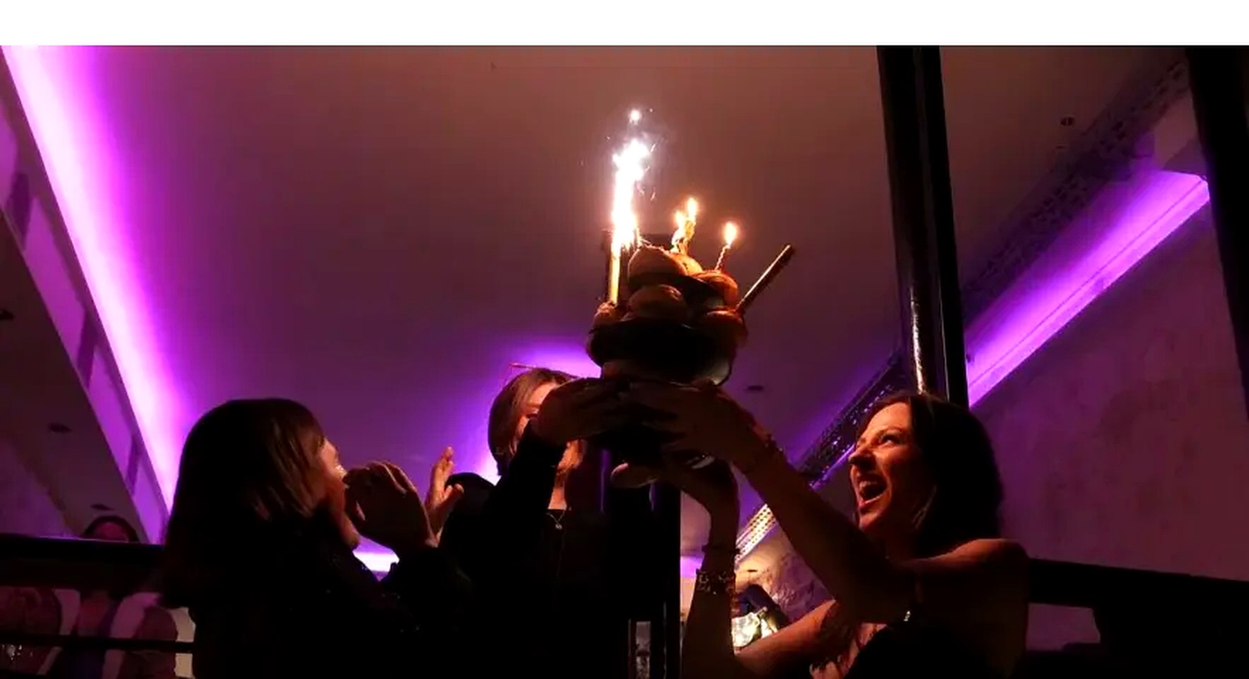 Gâteau d'anniversaire avec cierges magiques dans la salle du Le 40